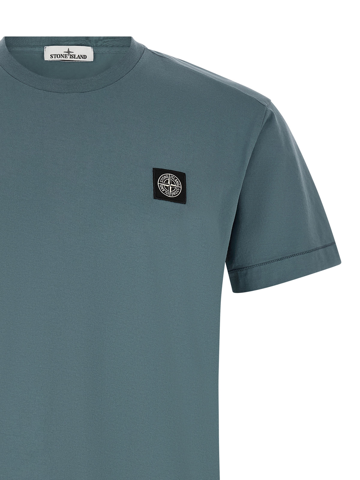 Elevate your wardrobe with the Stone Island Blue Cotton T-Shirt, crafted from luxurious garment-dyed cotton, embodying timeless sophistication and effortless style.