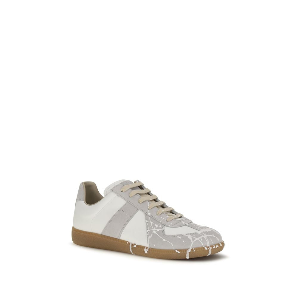 Experience the allure of Maison Margiela's Replica Sneakers, where exquisite gray suede meets contemporary design, embodying luxury and effortless style for the discerning individual.
