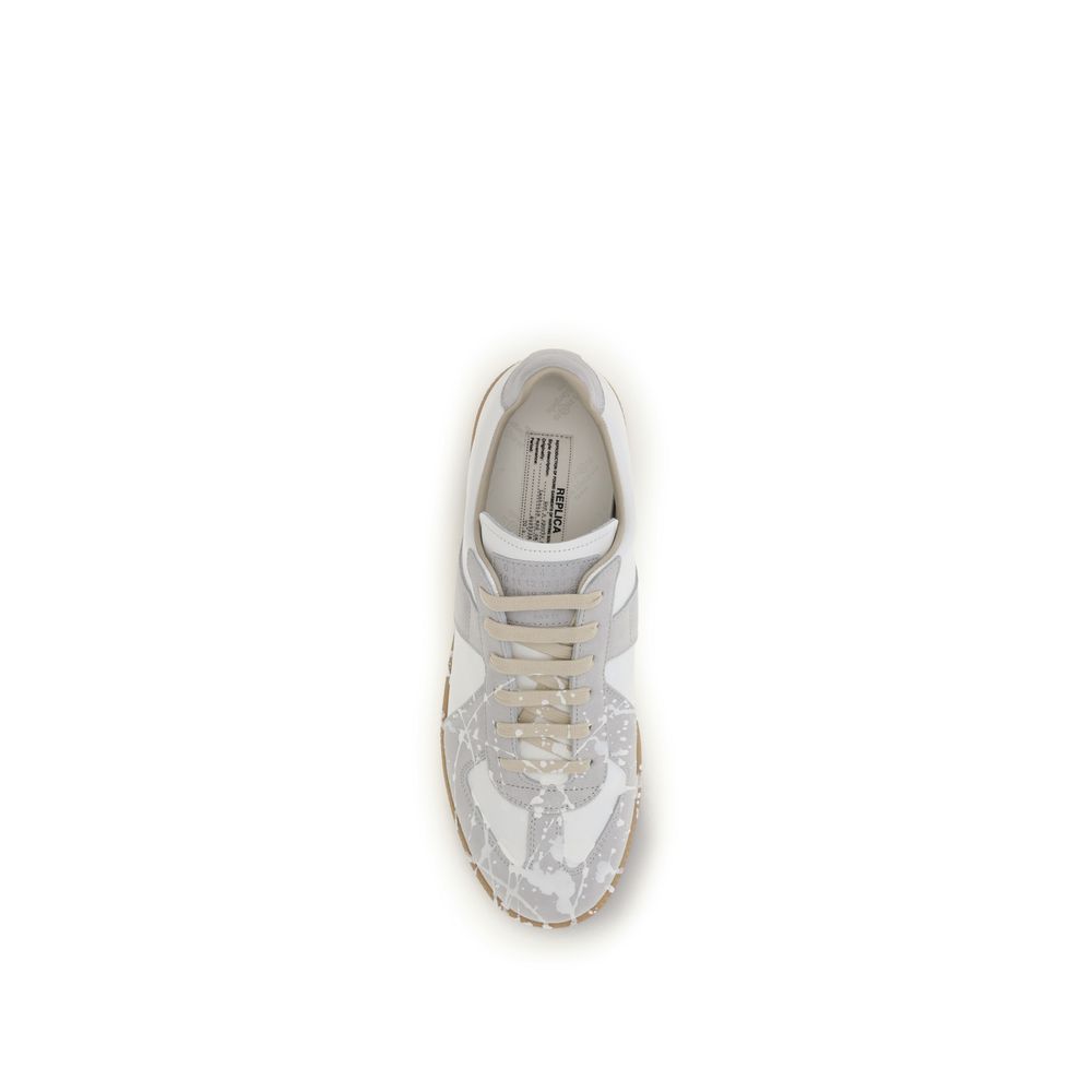 Indulge in the Maison Margiela Gray Suede Leather Low Top Sneakers, a masterpiece of contemporary design, crafted for those who appreciate exquisite luxury and timeless elegance.