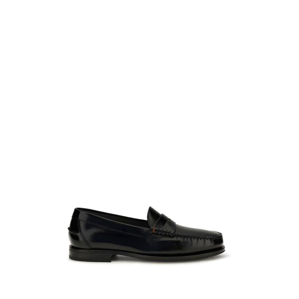 Elevate your style with Santoni Black Calf Leather Bos Taurus Slip-On Loafers, a masterpiece of craftsmanship and elegance, perfect for discerning tastes.