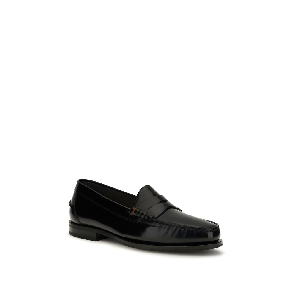 Indulge in the exquisite Santoni Black Calf Leather Bos Taurus Slip-On Loafers, where timeless craftsmanship meets modern elegance, perfect for the discerning individual.