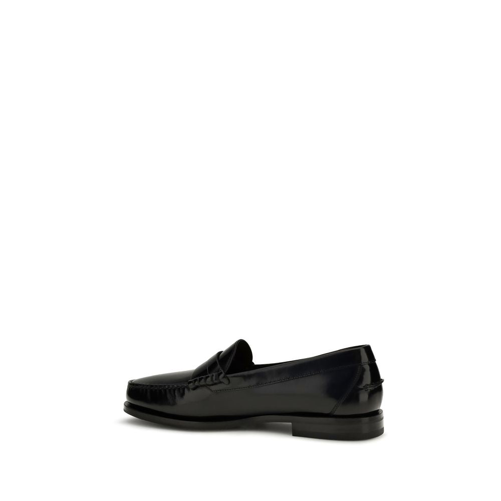 Elevate your style with Santoni Black Calf Leather Bos Taurus Slip-On Loafers, a timeless blend of sophistication and craftsmanship, perfect for any discerning wardrobe.