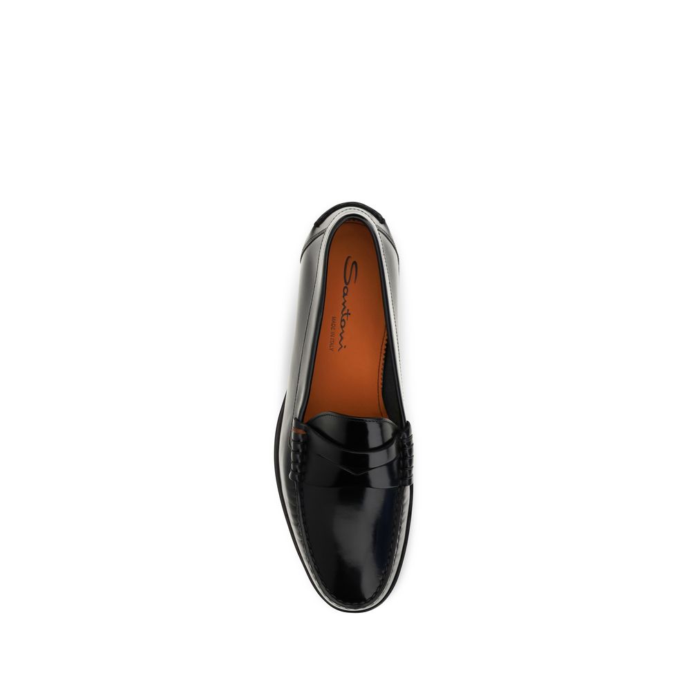 Experience the exquisite craftsmanship of Santoni Black Calf Leather Bos Taurus Slip-On Loafers, where timeless elegance meets modern sophistication for discerning tastes.