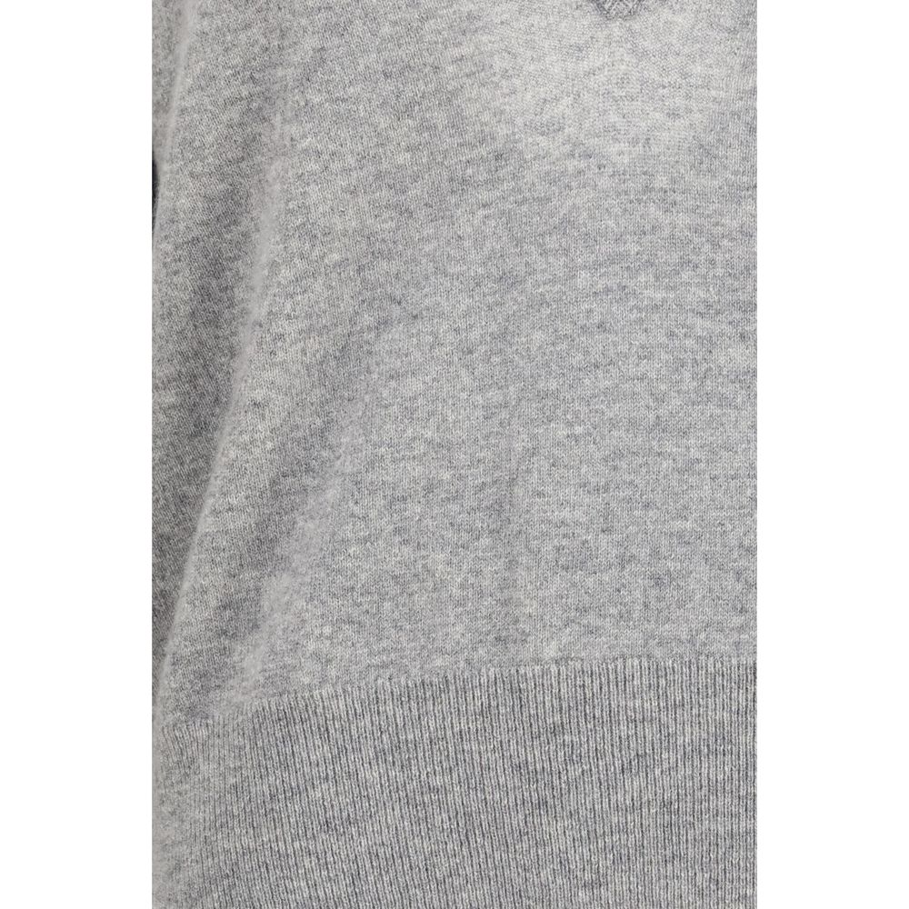 Indulge in the exquisite N°491 V-neck cashmere sweater by Extreme Cashmere, crafted from lightweight open-knit cashmere for timeless elegance and comfort.