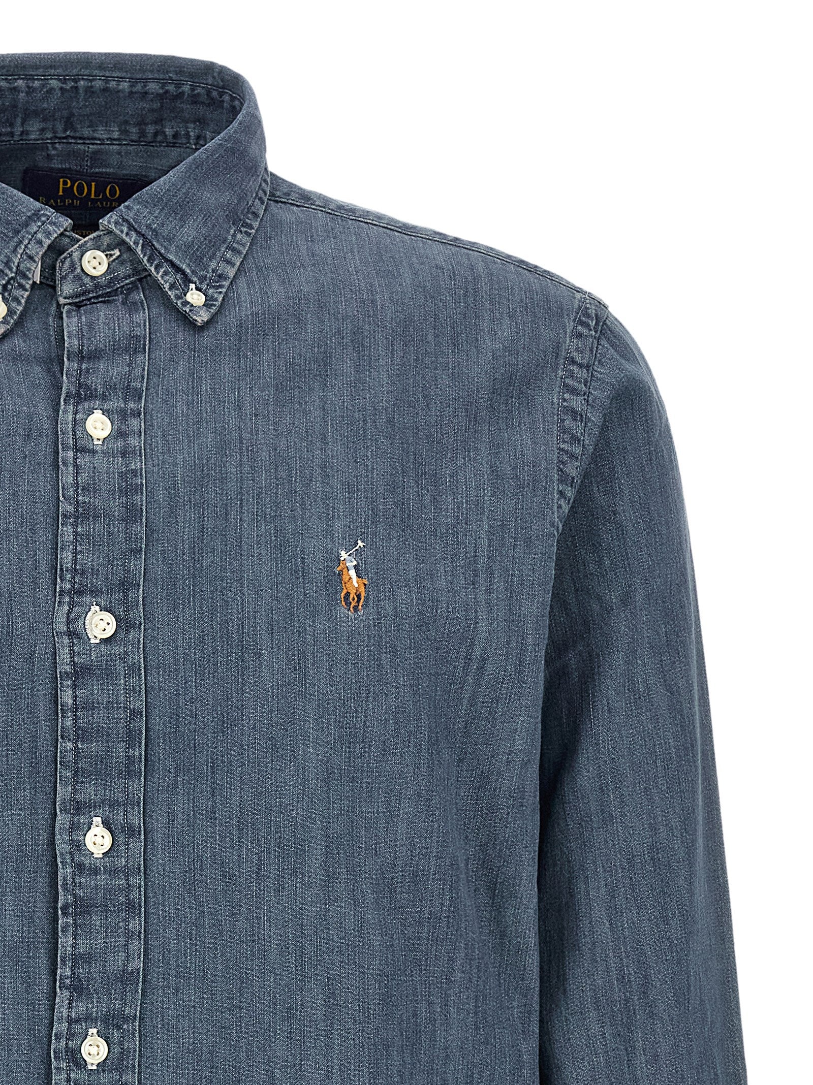 Elevate your wardrobe with the Polo Ralph Lauren Blue Cotton Blouse, a masterpiece of casual elegance crafted from pure cotton denim, embodying timeless sophistication and comfort.