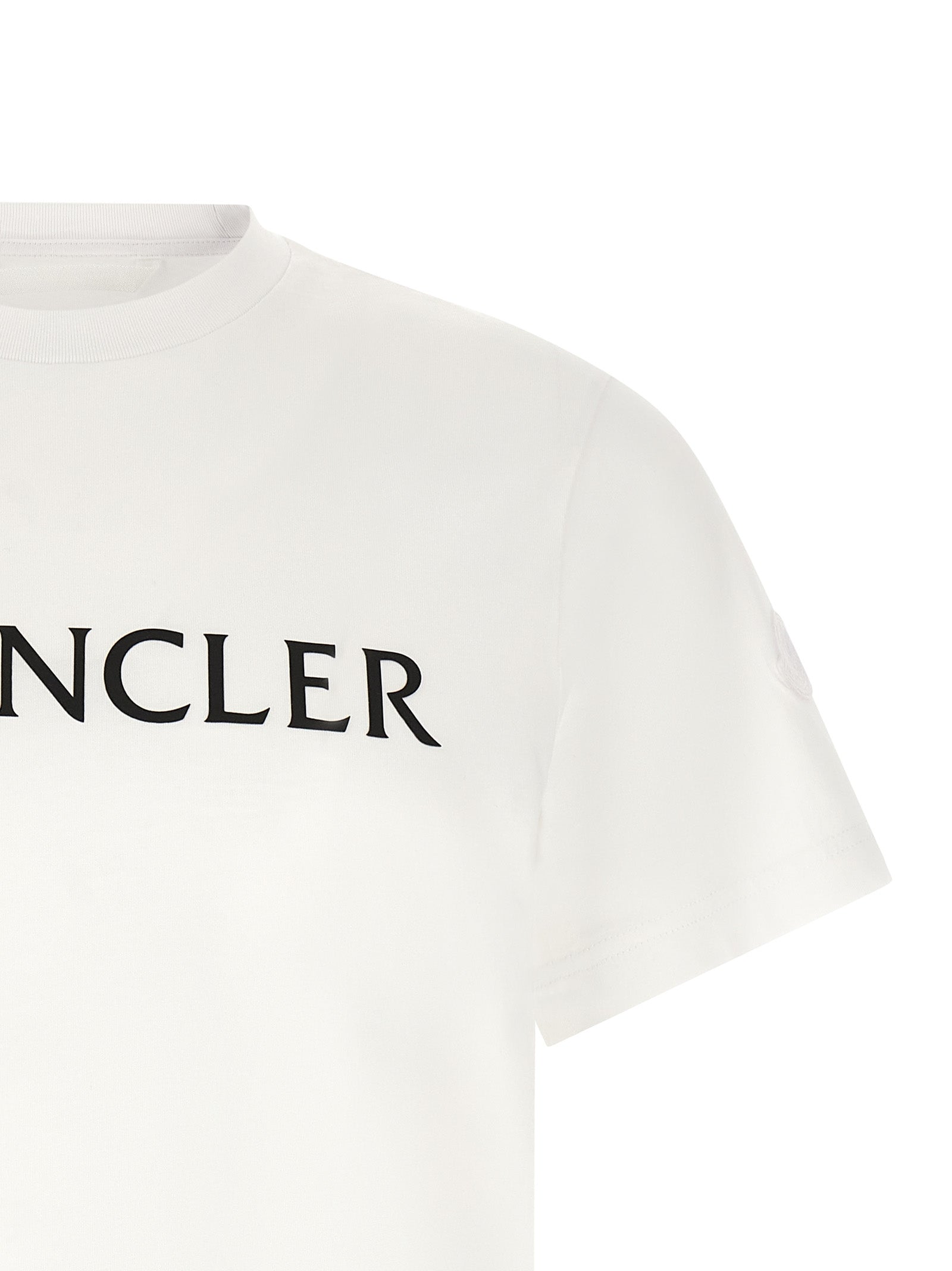 Elevate your wardrobe with the Moncler White Cotton T-Shirt, a masterpiece of refined irony and luxurious comfort, perfect for the discerning individual.