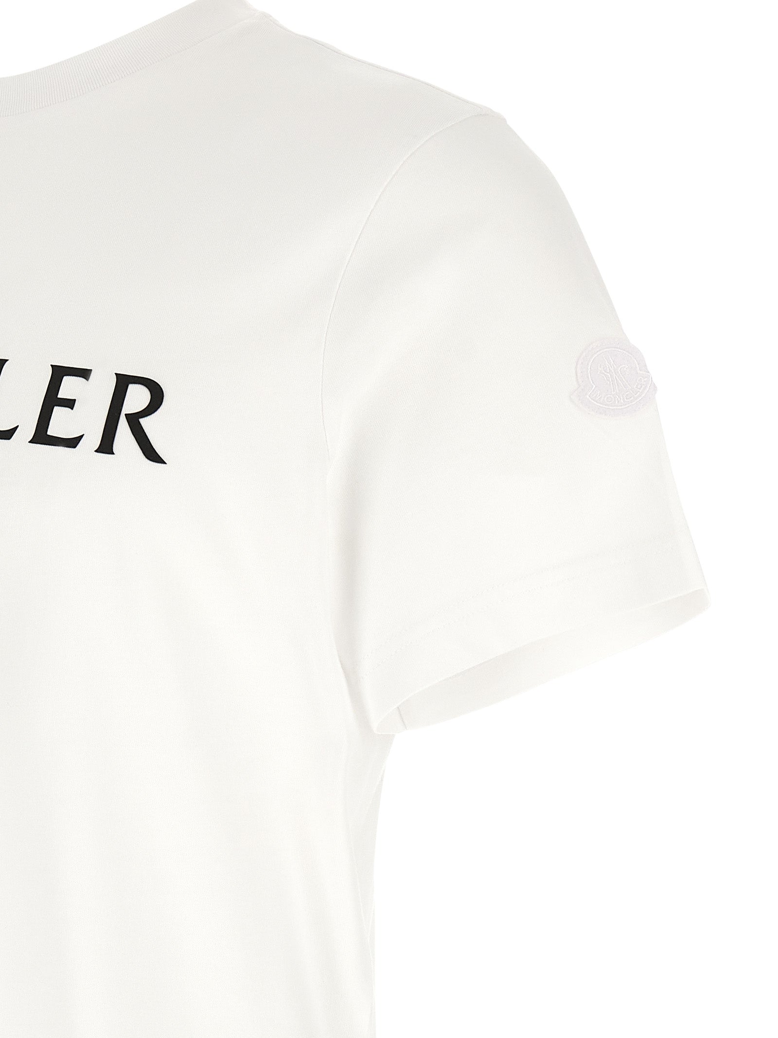 Elevate your wardrobe with the Moncler White Cotton T-Shirt, a blend of luxury and comfort featuring an iconic graphic logo, perfect for the discerning individual.