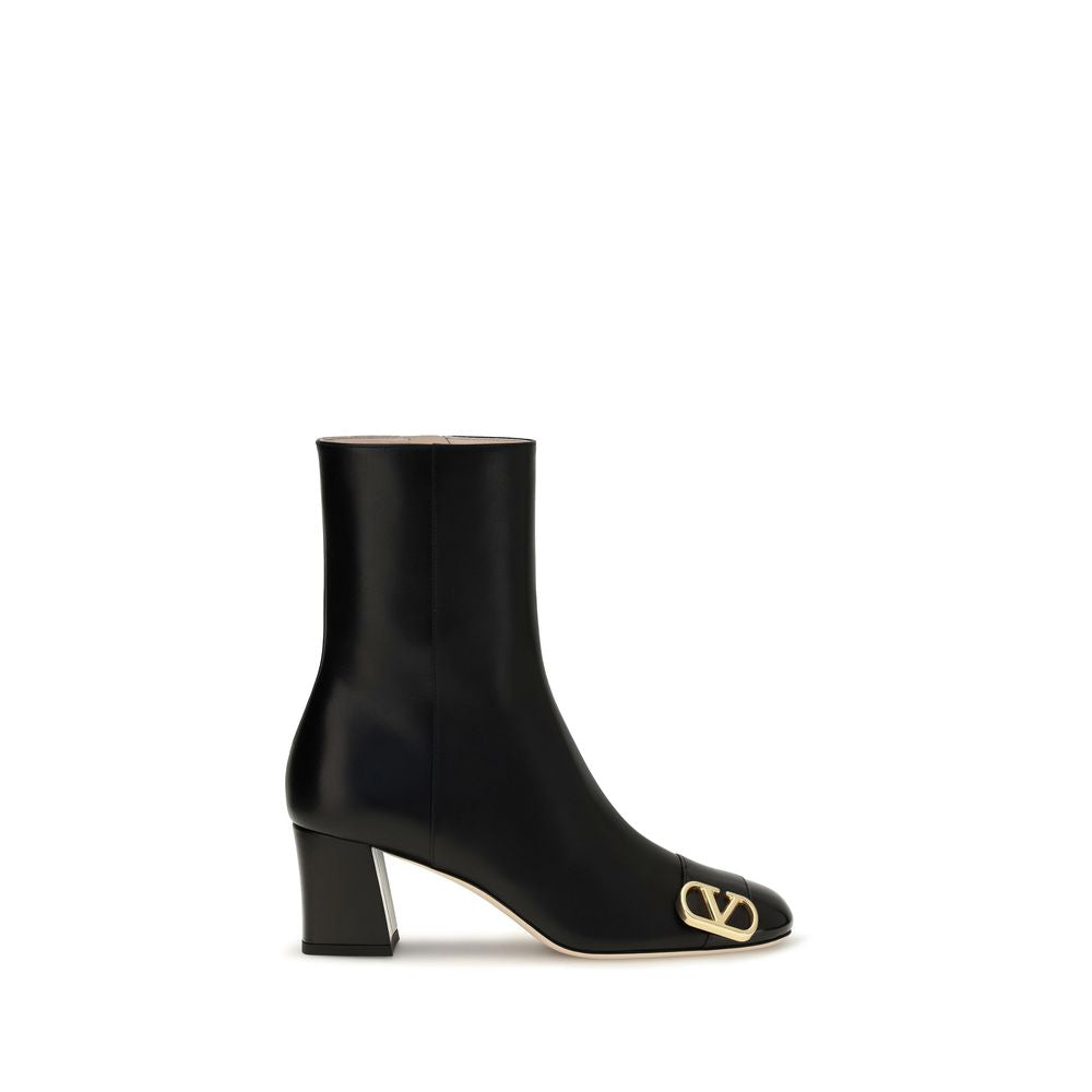 Indulge in the exquisite craftsmanship of Valentino Garavani's Black Calf Leather Bos Taurus Ankle Boots, where polished elegance meets architectural design for a timeless statement.