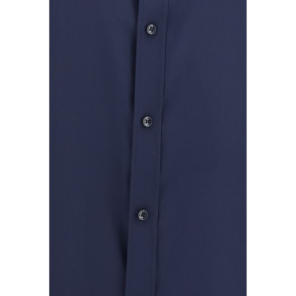 Discover the exquisite Dolce & Gabbana Blue Silk Dress Shirt, a masterpiece of refined crêpe de chine, embodying timeless elegance and sophisticated allure.