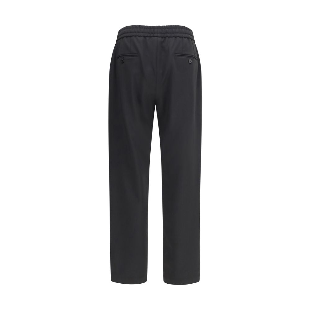 Elevate your wardrobe with Dolce & Gabbana's Black Wool Oves Aries Joggers, a fusion of tailored elegance and everyday comfort, crafted from luxurious stretch virgin wool gabardine.