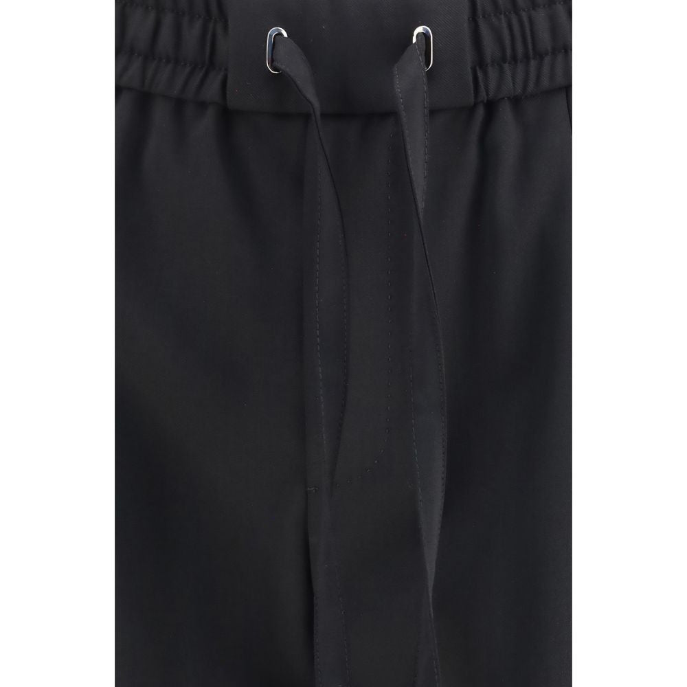 Experience the elegance of Dolce & Gabbana's Black Wool Oves Aries Joggers, crafted from premium stretch virgin wool for a refined, versatile silhouette that elevates everyday luxury.