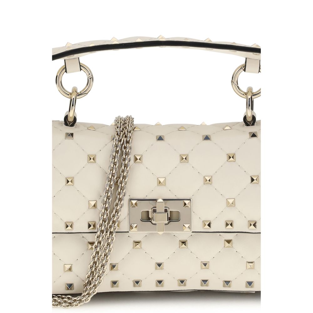Indulge in the elegance of the Valentino Garavani Rockstud Spike mini Top Handle Bag, crafted from luxurious lamb nappa leather, where sophistication meets timeless allure.