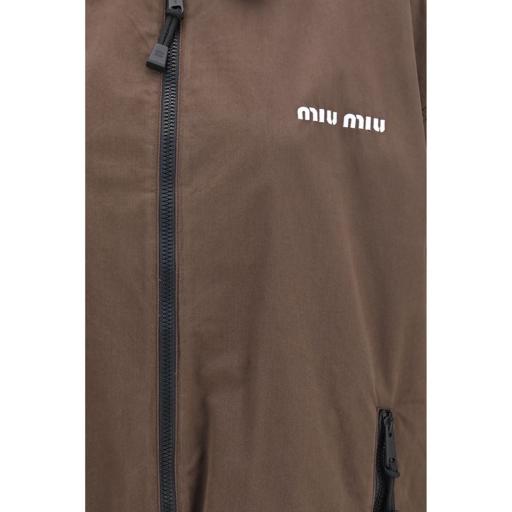 Elevate your style with the Miu Miu Brown Cotton Full-Length Jacket, a masterpiece of unlined elegance and oversized sophistication, perfect for any occasion.