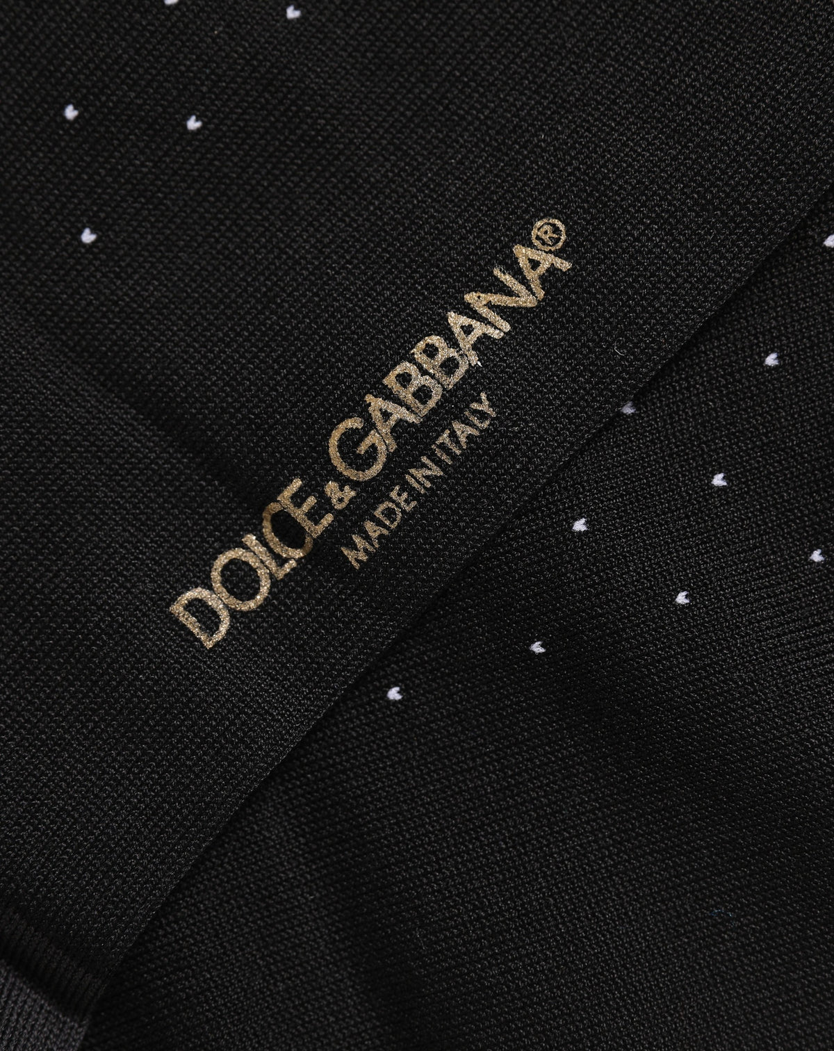 Experience the allure of Dolce & Gabbana's Black Cotton Polka Dot Socks, crafted in Italy for those who embrace luxury and sophistication in every step.