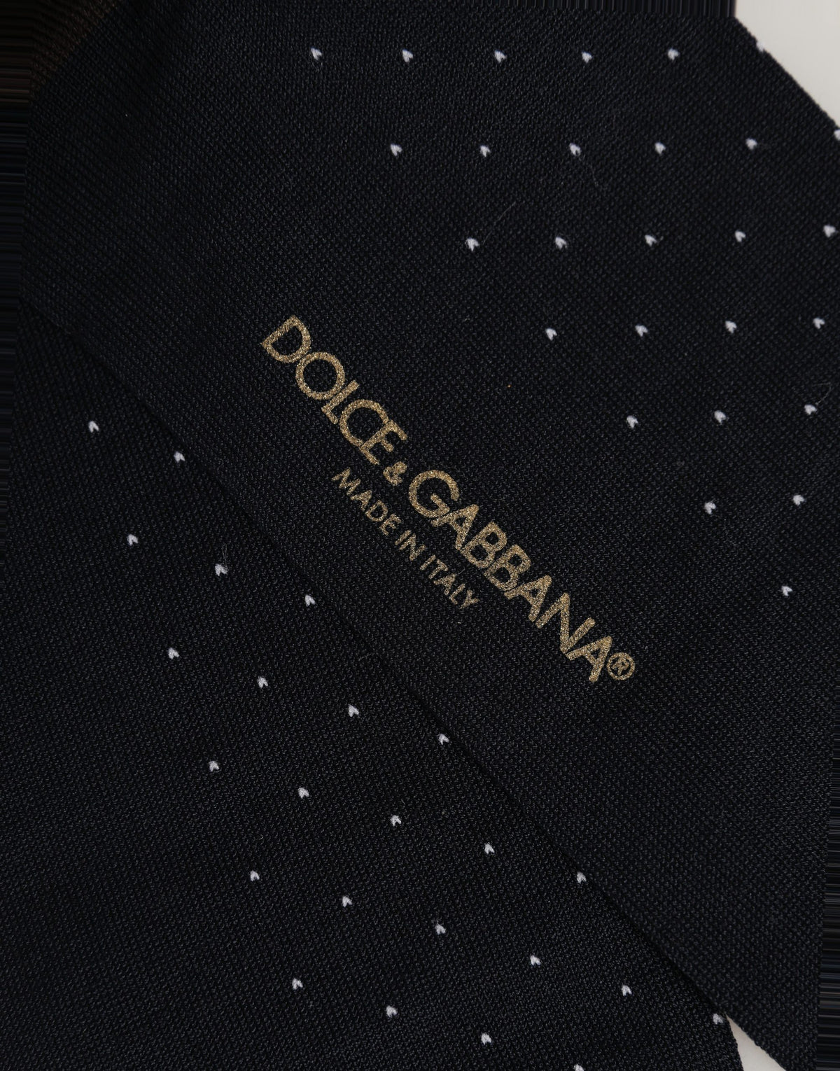 Elevate your wardrobe with Dolce & Gabbana's Black Cotton Polka Dot Over The Calf Socks, crafted in Italy for the discerning individual who appreciates luxury and style.