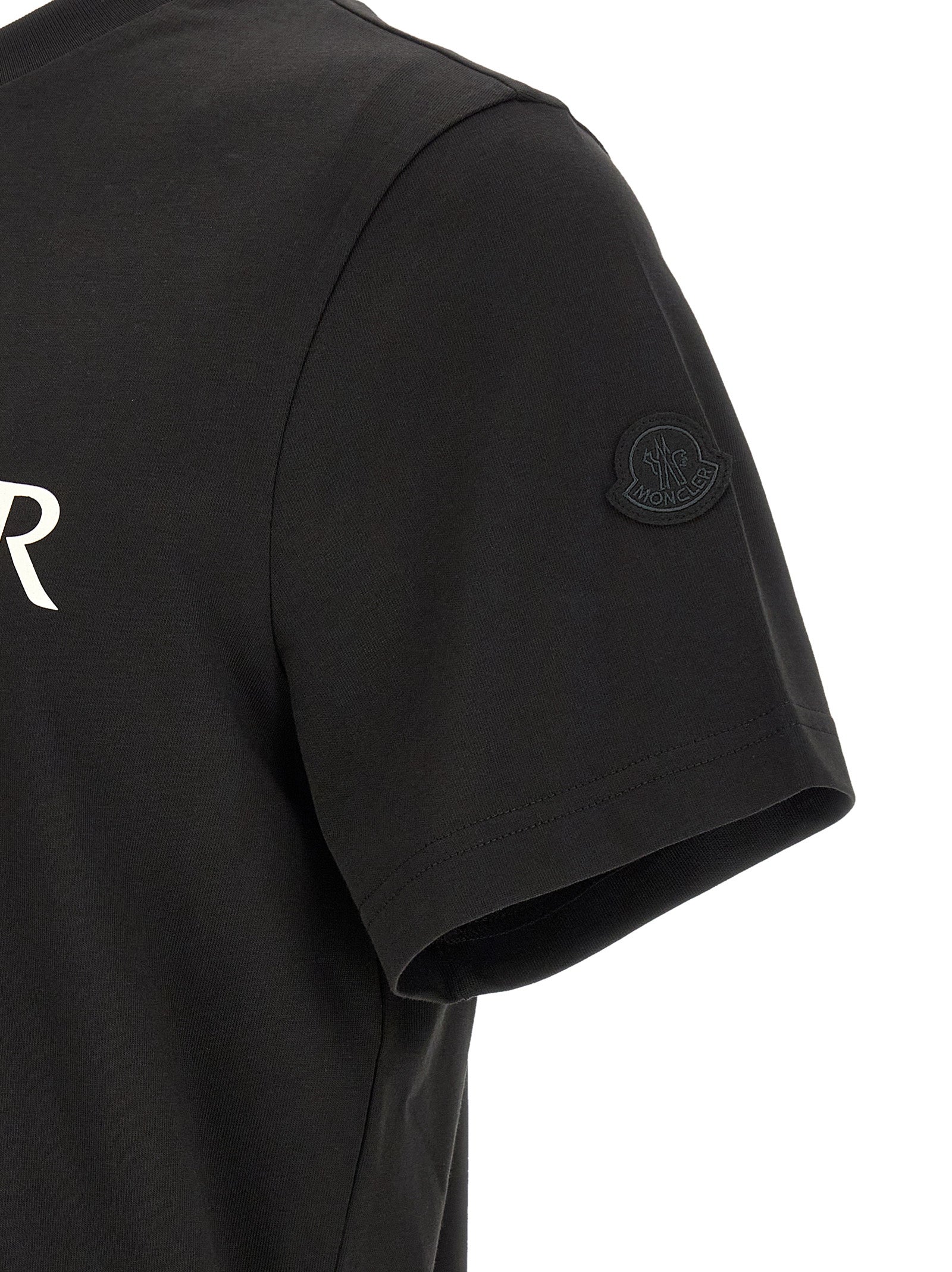 Discover the Moncler Black Cotton T-Shirt, a masterpiece of casual luxury that elevates your wardrobe with its iconic design and impeccable craftsmanship.
