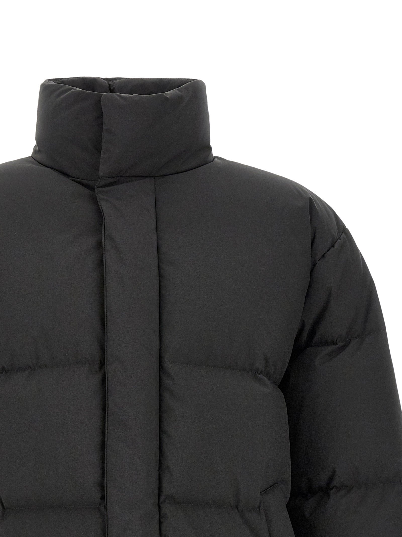 Elevate your winter wardrobe with the Saint Laurent Black Polyester Full-Length Jacket, a masterpiece of geometric quilting and seamless design, embodying refined elegance and architectural sophistication.