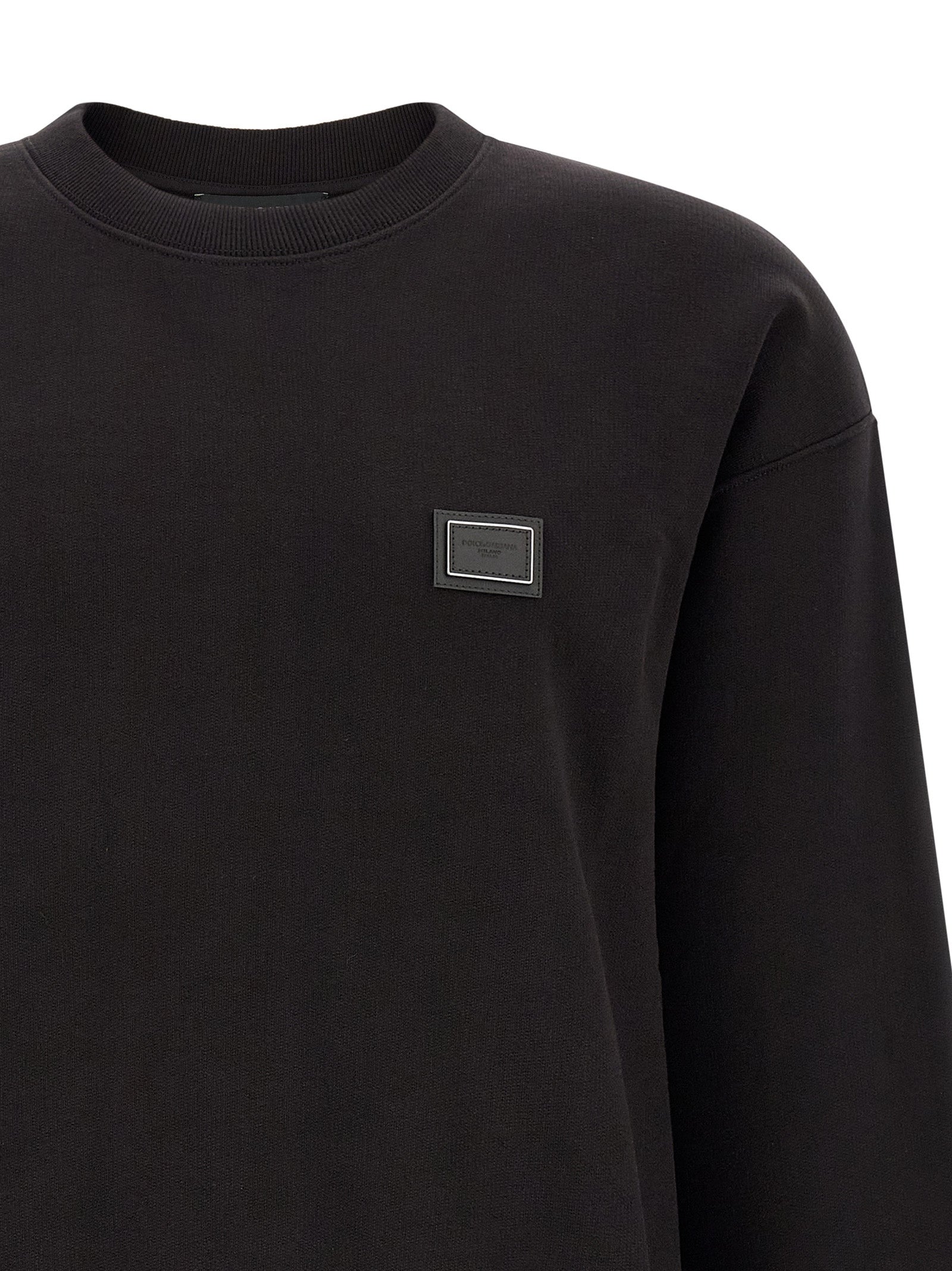 Indulge in the exquisite Dolce & Gabbana Black Cotton Sweatshirt, a masterclass in luxury and craftsmanship that elevates everyday elegance for the discerning individual.