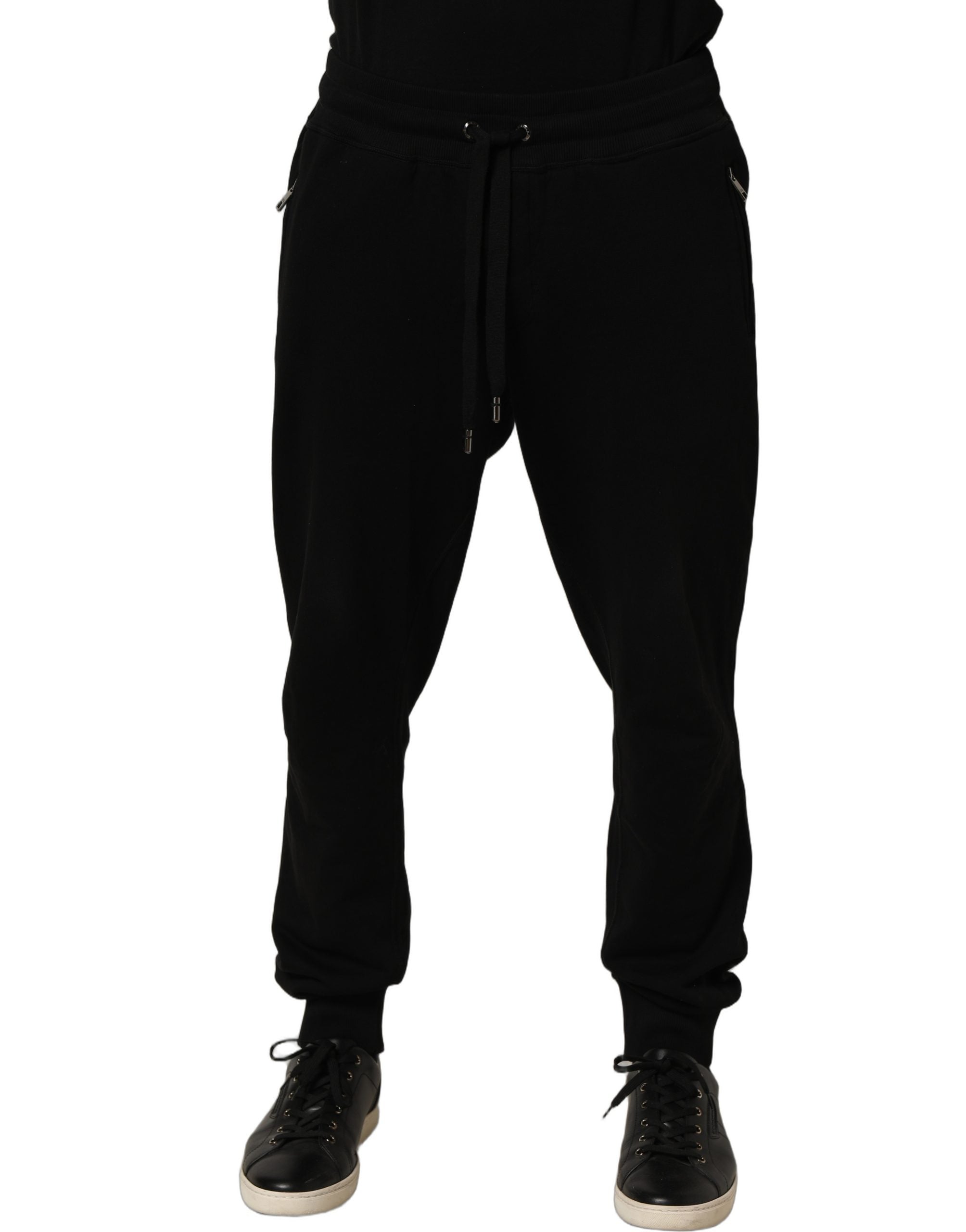 Indulge in the exquisite allure of Dolce & Gabbana's Black Cotton Logo Jogger Sweatpants, where luxurious craftsmanship meets timeless elegance for the discerning individual.