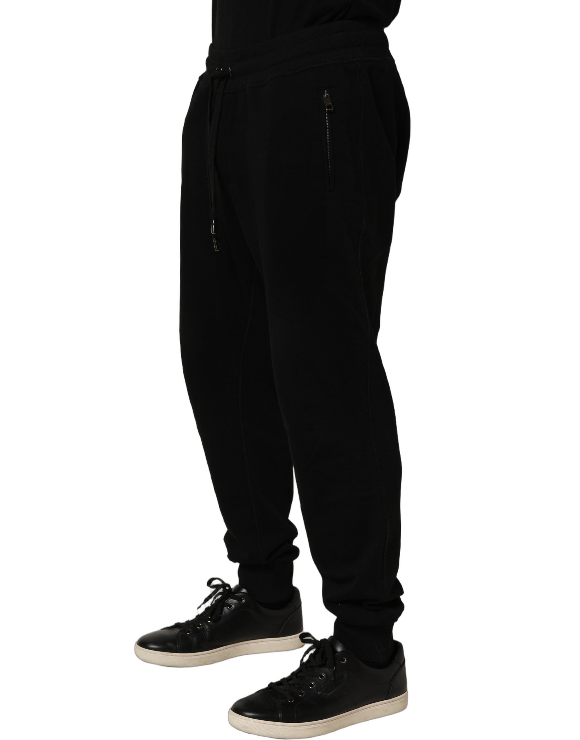 Indulge in the exquisite allure of Dolce & Gabbana's Black Cotton Logo Jogger Sweatpants, where luxurious craftsmanship meets timeless elegance for the discerning individual.