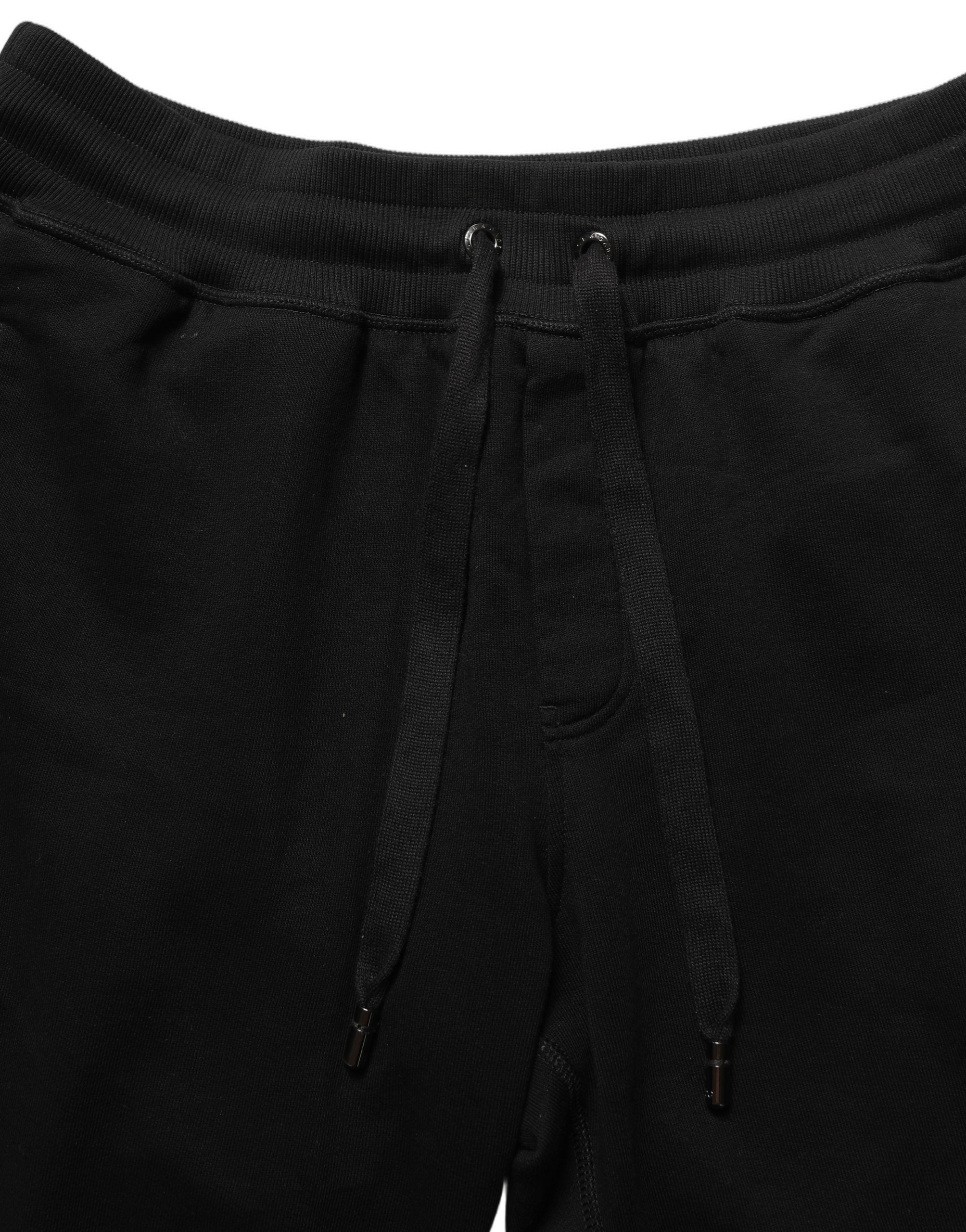Indulge in the sophistication of Dolce & Gabbana's Black Cotton Logo Jogger Sweatpants, where exquisite craftsmanship meets timeless elegance for the discerning individual.