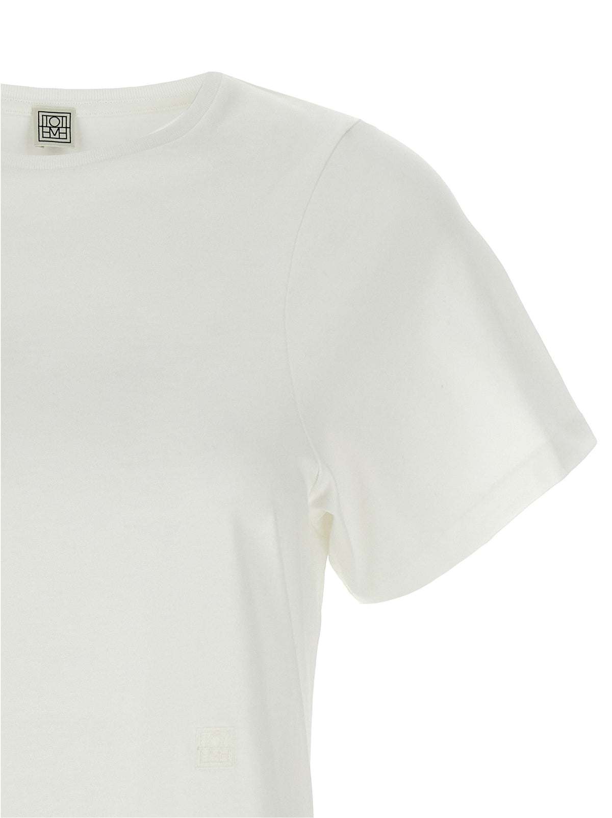 Indulge in the refined elegance of the TOTEME White Cotton T-Shirt, a luxurious essential crafted from pure cotton, perfect for the modern connoisseur's wardrobe.