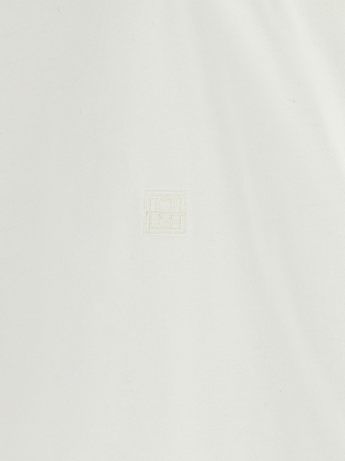 Elevate your wardrobe with the TOTEME White Cotton T-Shirt, a luxurious essential crafted from 100% cotton, embodying refined simplicity and timeless elegance.