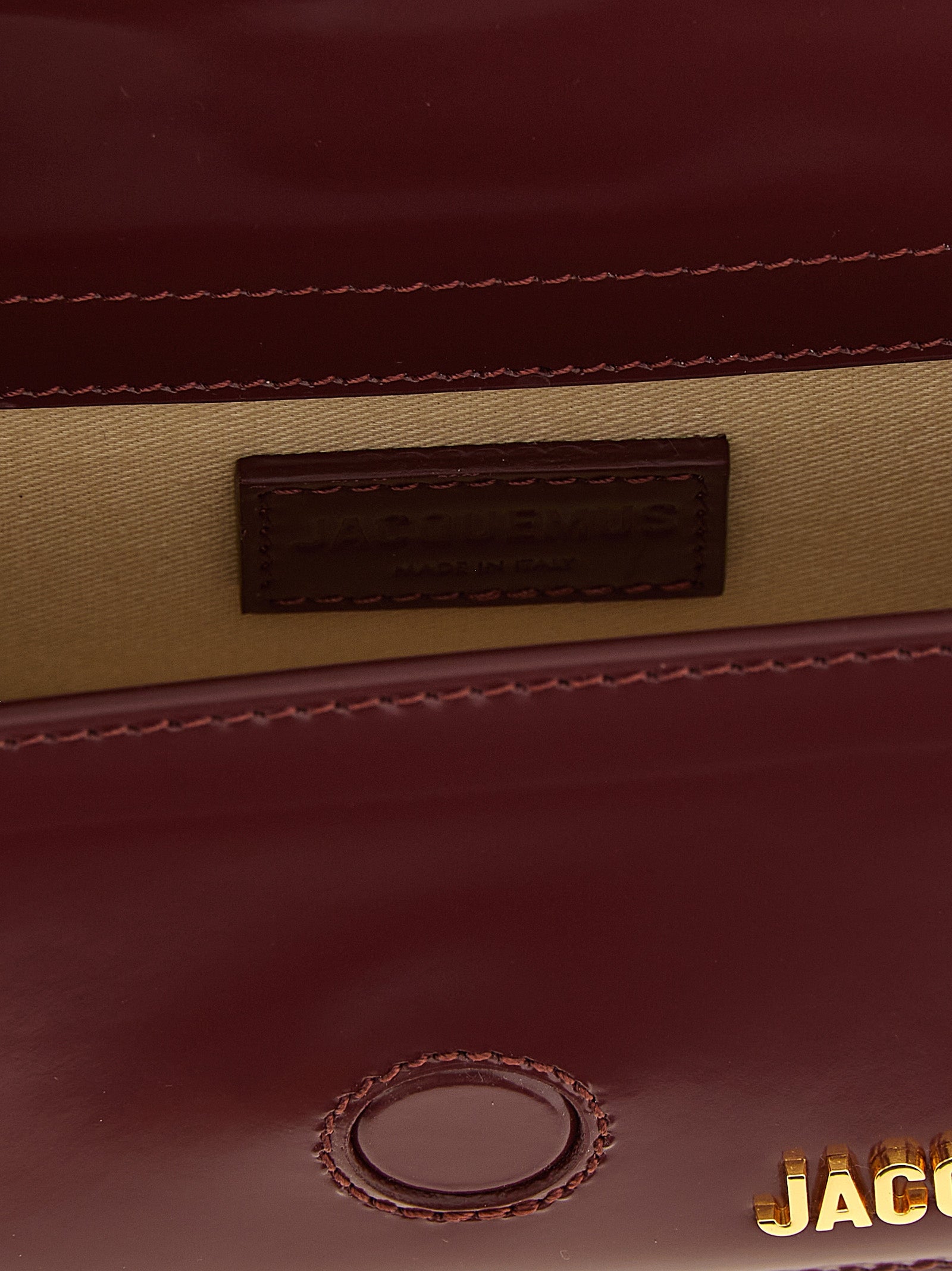 Indulge in the exquisite Jacquemus Bordeaux Calfskin Handbag, a sculptural masterpiece of luxurious calfskin leather, perfect for the avant-garde fashionista seeking timeless elegance.