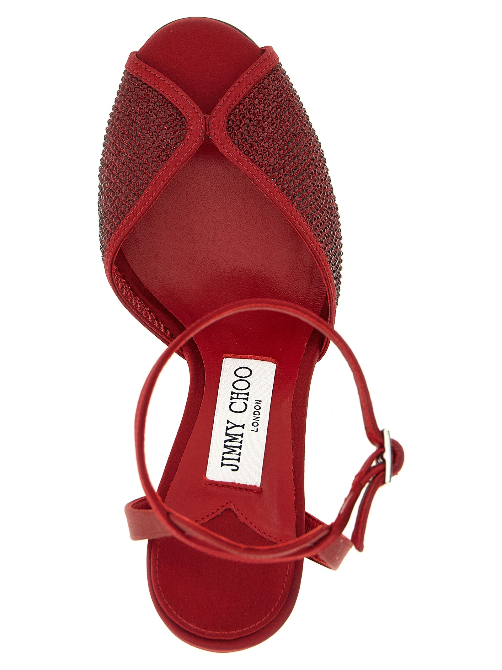 Indulge in the exquisite allure of Jimmy Choo's Sacora sandals, where luxurious red lamb leather meets dazzling micro crystals, elevating your elegance with every step.