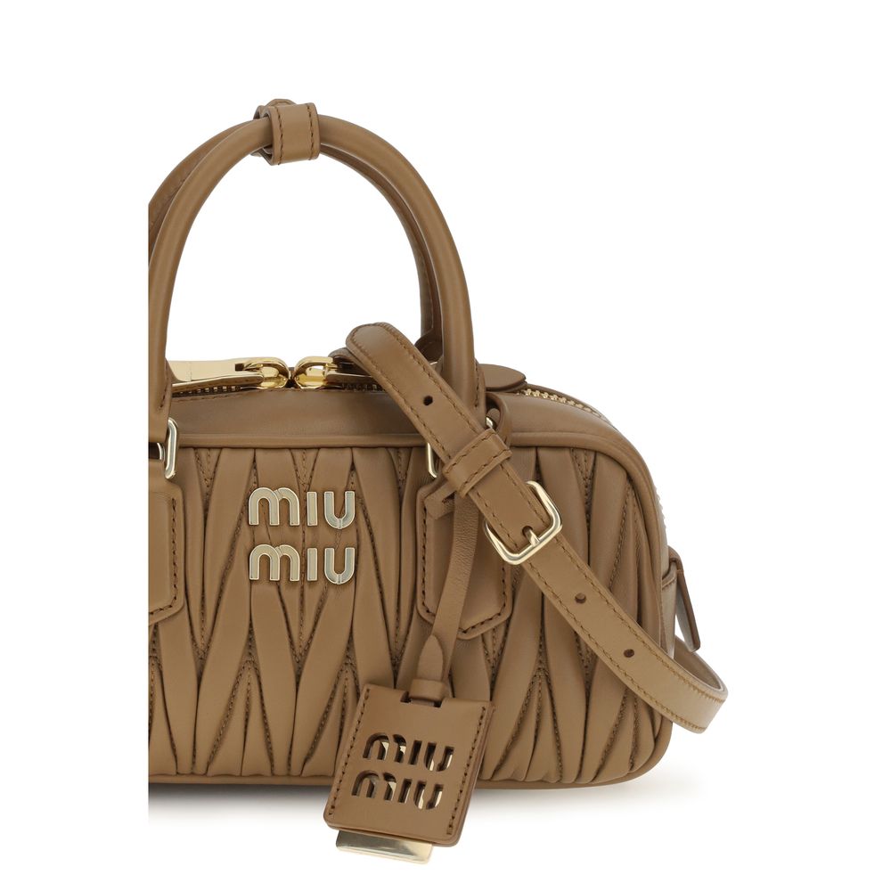 Discover the Miu Miu Beige Calf Leather Bos Taurus Handbag, a timeless masterpiece of luxury and sophistication, perfect for the discerning individual who values elegance.