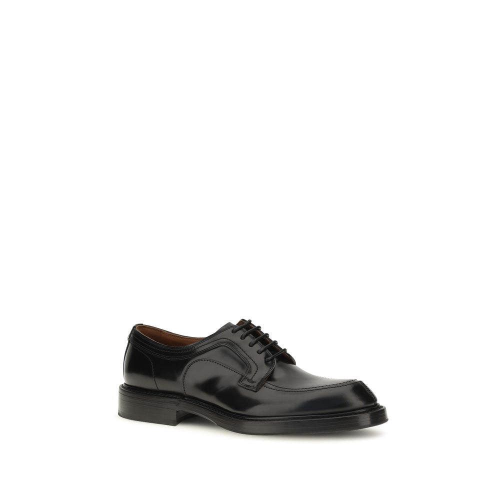 Indulge in the timeless elegance of Dolce & Gabbana's Black Calf Leather Bos Taurus Oxfords, where exquisite craftsmanship meets sophisticated style for the discerning individual.