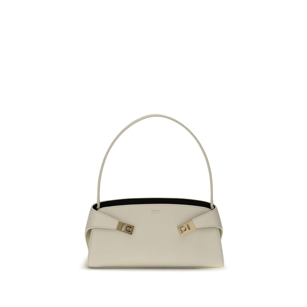 Indulge in the exquisite elegance of the Ferragamo Beige Calf Leather Bos Taurus Shoulder Bag, a timeless accessory that embodies luxury and sophistication for any occasion.