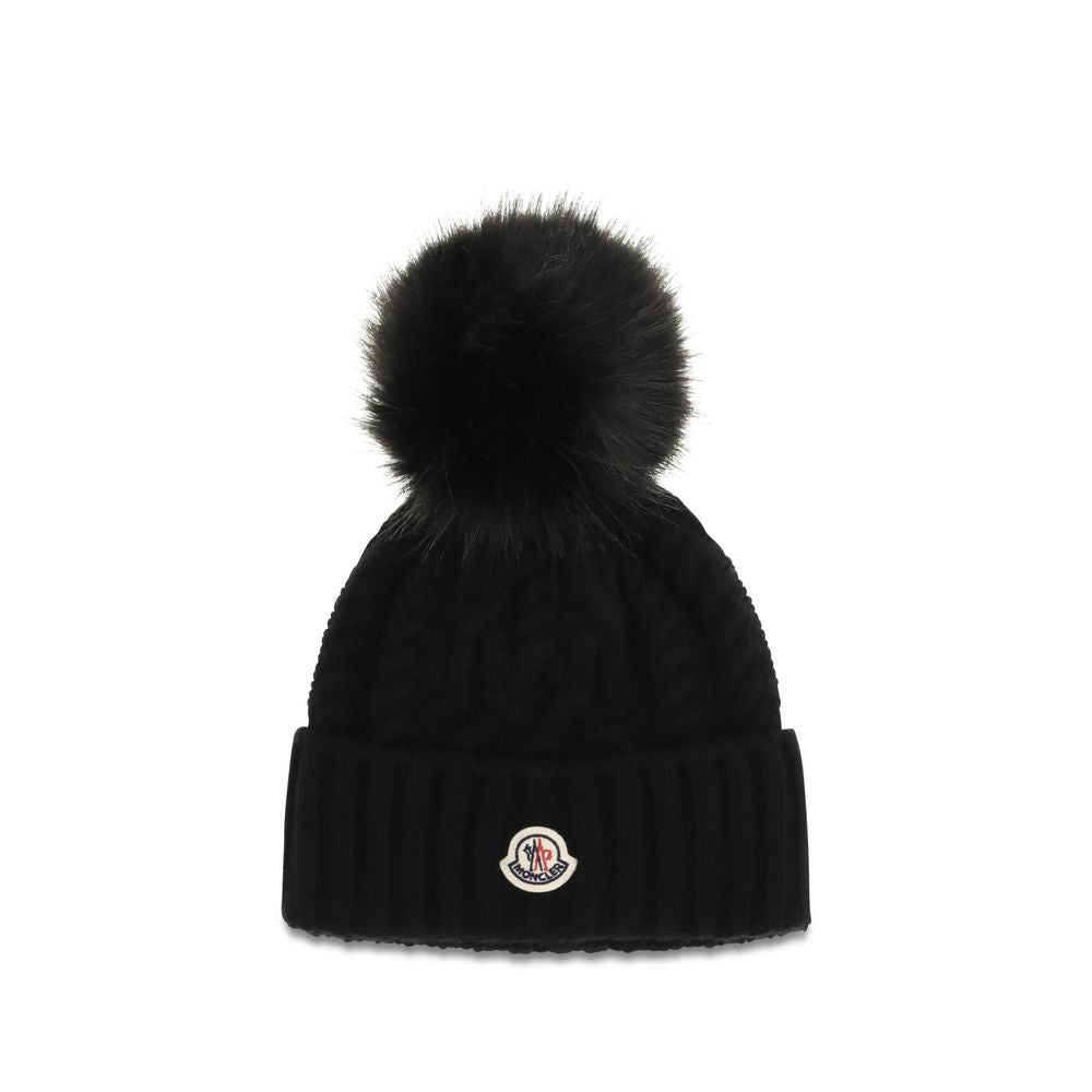 Indulge in the Moncler Black Wool Oves Aries Beanie, a luxurious blend of fleece wool and cashmere, crafted for warmth and elegance in every winter moment.