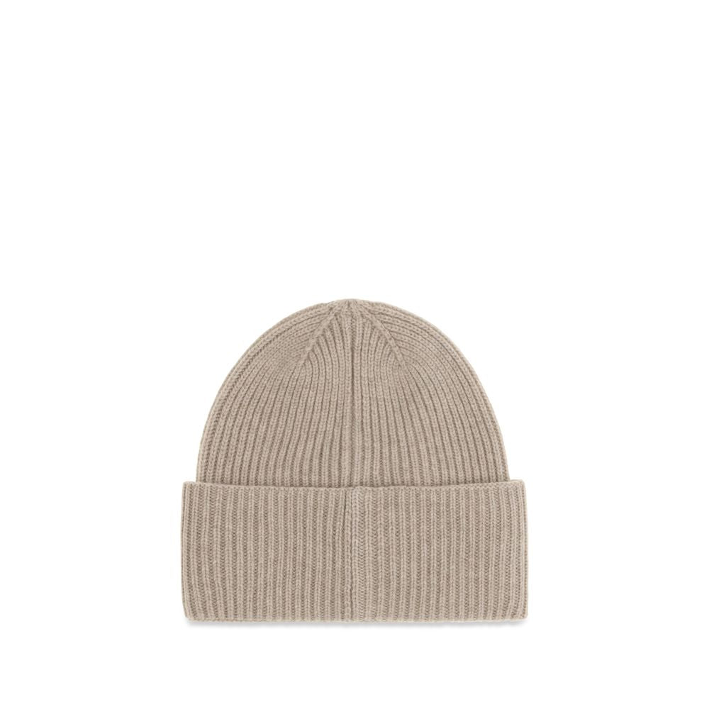 Indulge in the Max Mara Beige Cashmere Beanie, a luxurious accessory crafted from pure cashmere, embodying timeless elegance and sophisticated warmth for discerning tastes.