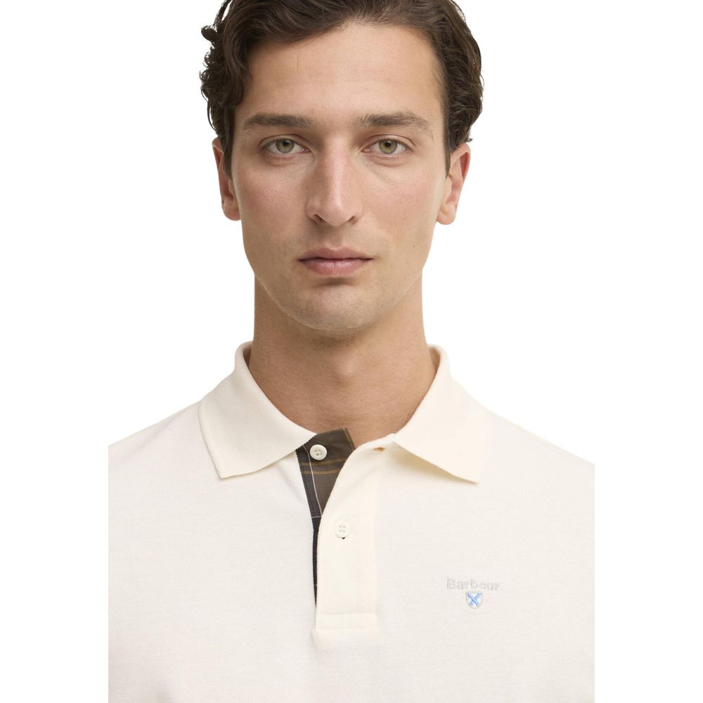 Discover the Barbour Cream Cotton Polo Shirt, a masterpiece of refined craftsmanship in 100% cotton, embodying timeless elegance for the discerning individual.