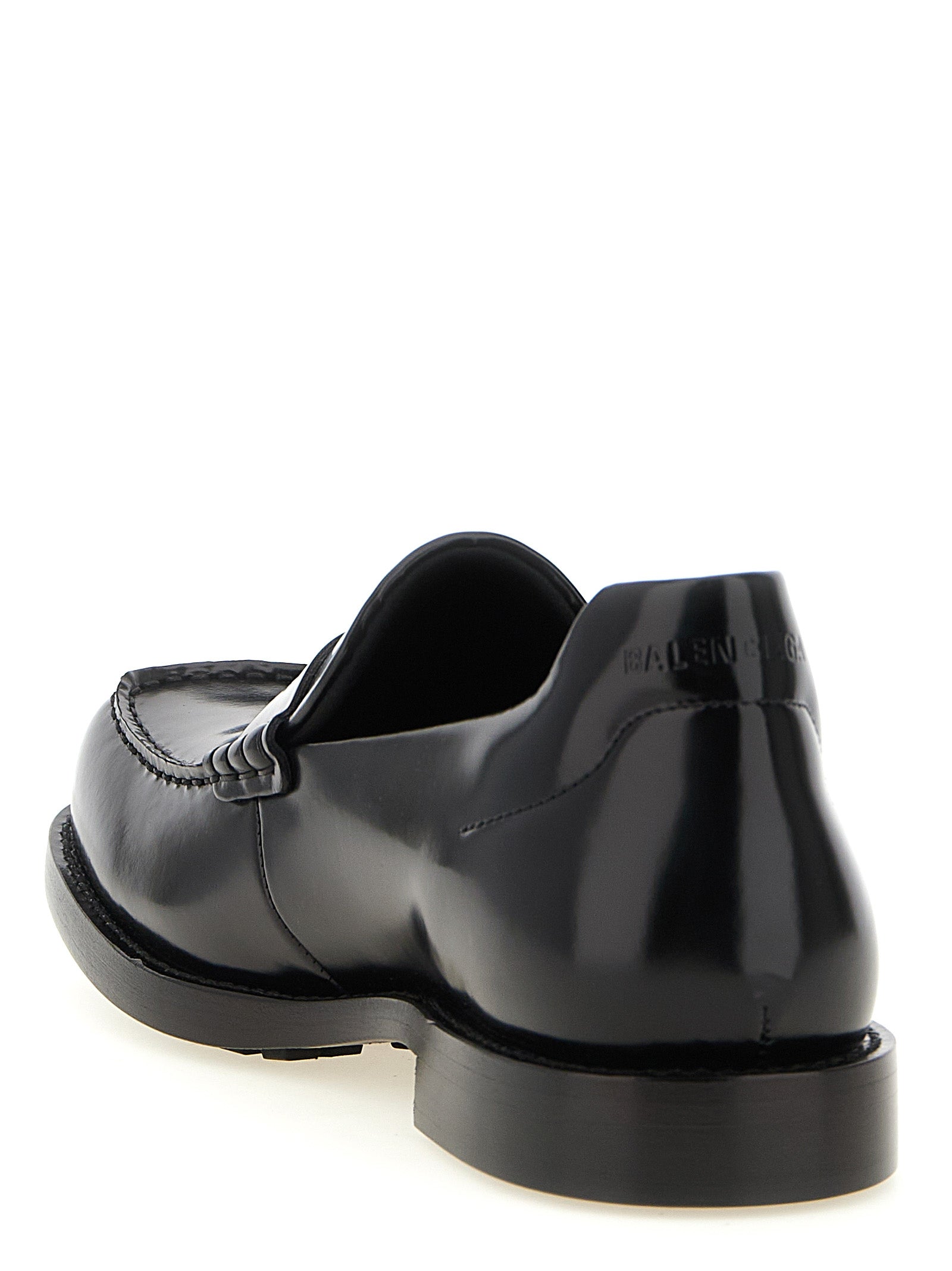 Experience the allure of Balenciaga Black Calfskin Slip-On Loafers, where exquisite craftsmanship meets timeless elegance, redefining luxury for the discerning individual.