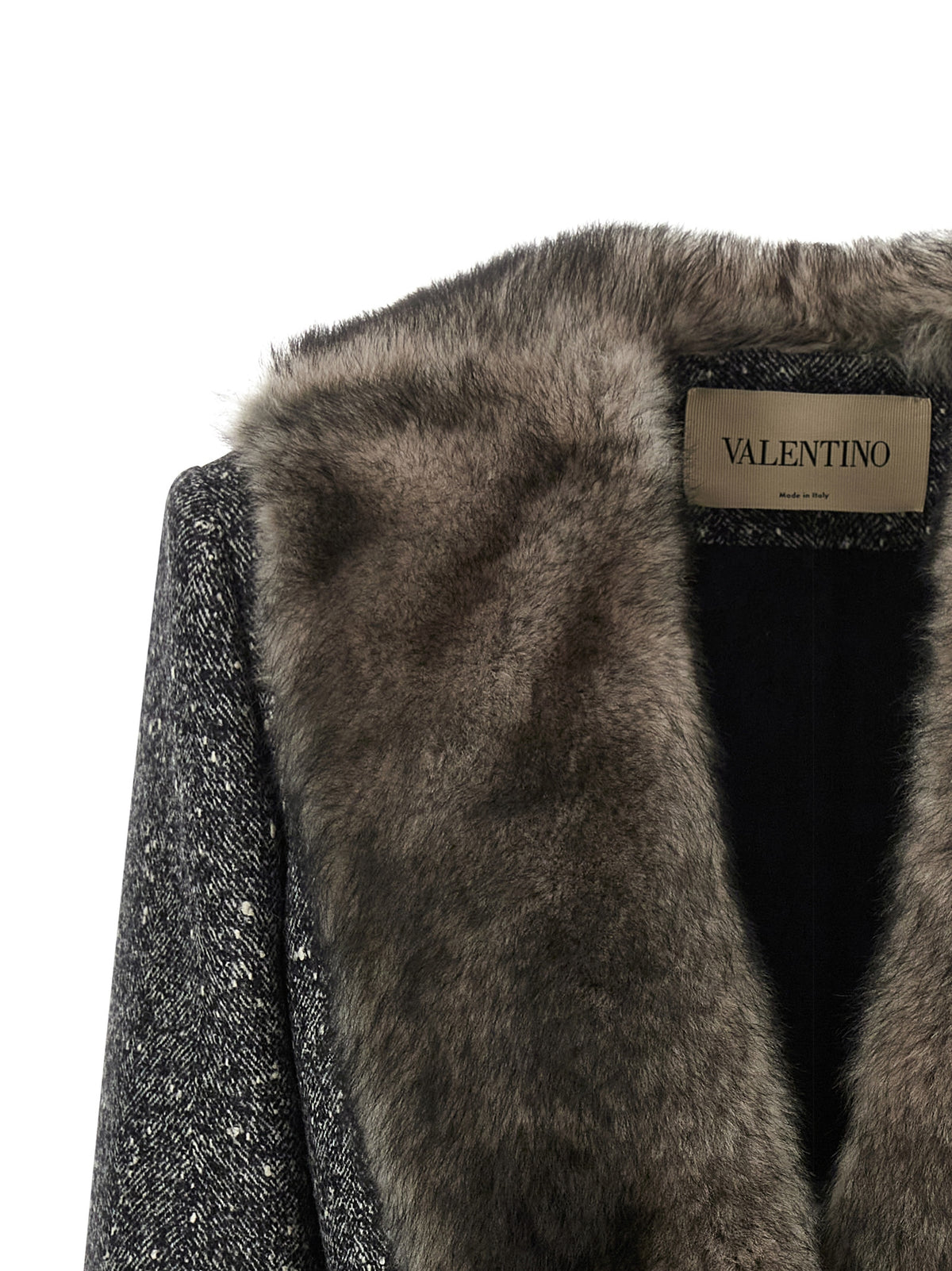 Elevate your winter wardrobe with the Valentino Garavani Bicolor Virgin Wool Coat, a masterpiece of luxurious craftsmanship and timeless elegance, perfect for any sophisticated occasion.