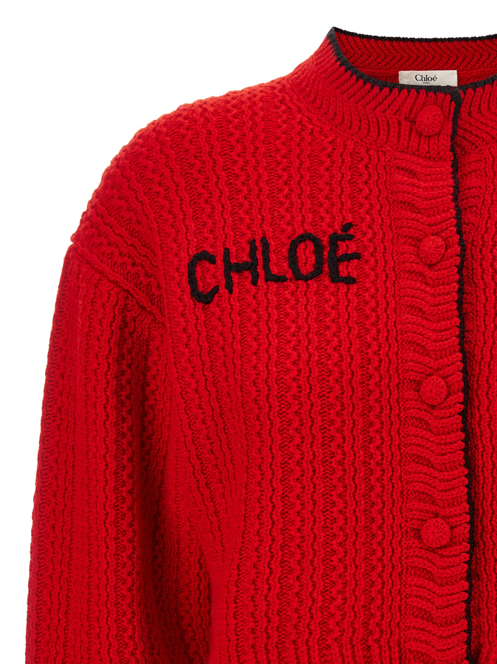 Indulge in the Chloé Red Wool Cardigan, a luxurious blend of 70% wool and 30% cashmere, where sophisticated style meets exquisite craftsmanship for the discerning fashion connoisseur.