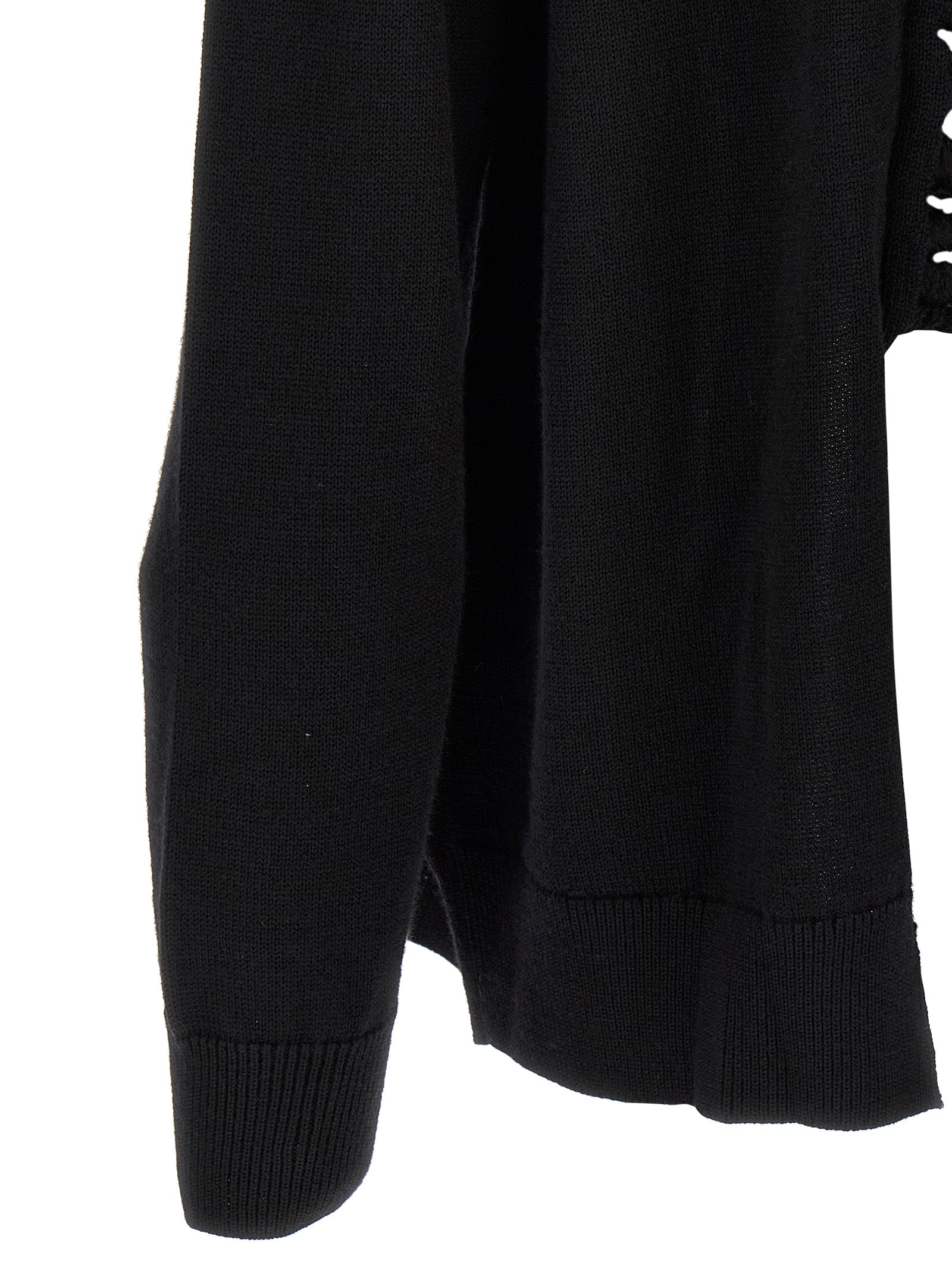 Discover the exquisite Comme Des Garçons Black Wool Cardigan, a masterpiece of avant-garde design and luxurious craftsmanship, perfect for the discerning wardrobe.