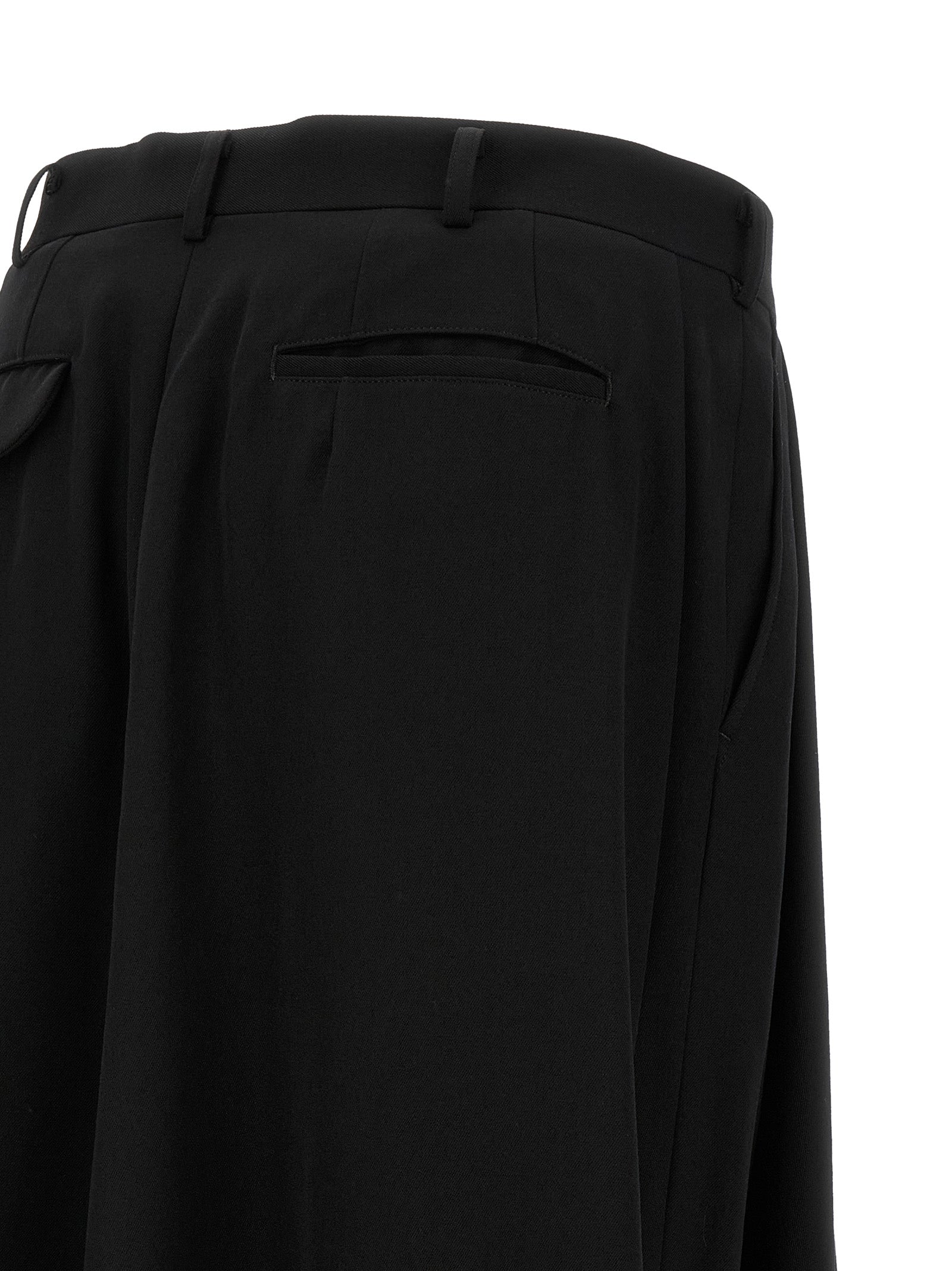 Elevate your wardrobe with Comme des Garçons Black Wool Dress Pants, a masterpiece of avant-garde design and luxurious craftsmanship, perfect for the discerning individual.