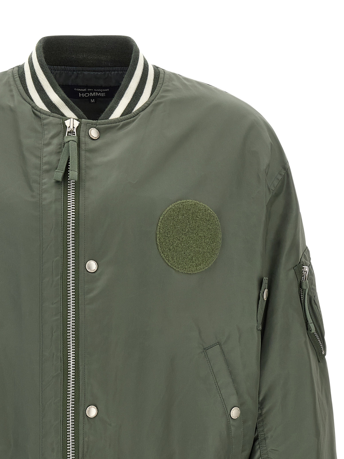 Elevate your style with the Comme Des Garçons Bicolor Nylon Bomber, a luxurious blend of modern design and timeless sophistication, crafted for the discerning individual.