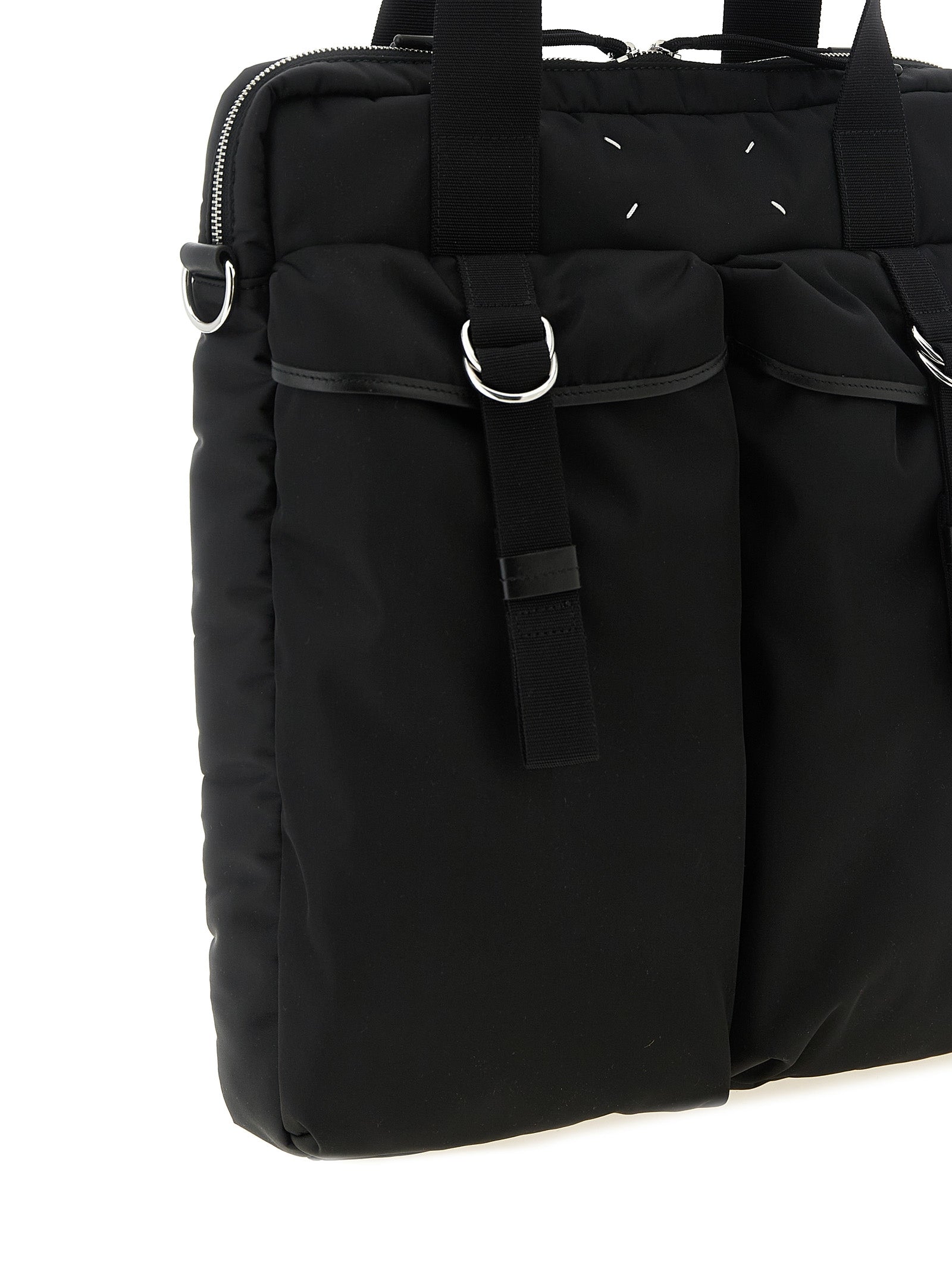 Discover the Maison Margiela Black Polyamide Tote Bag, a blend of industrial elegance and timeless allure, perfect for the discerning individual seeking unmatched sophistication.