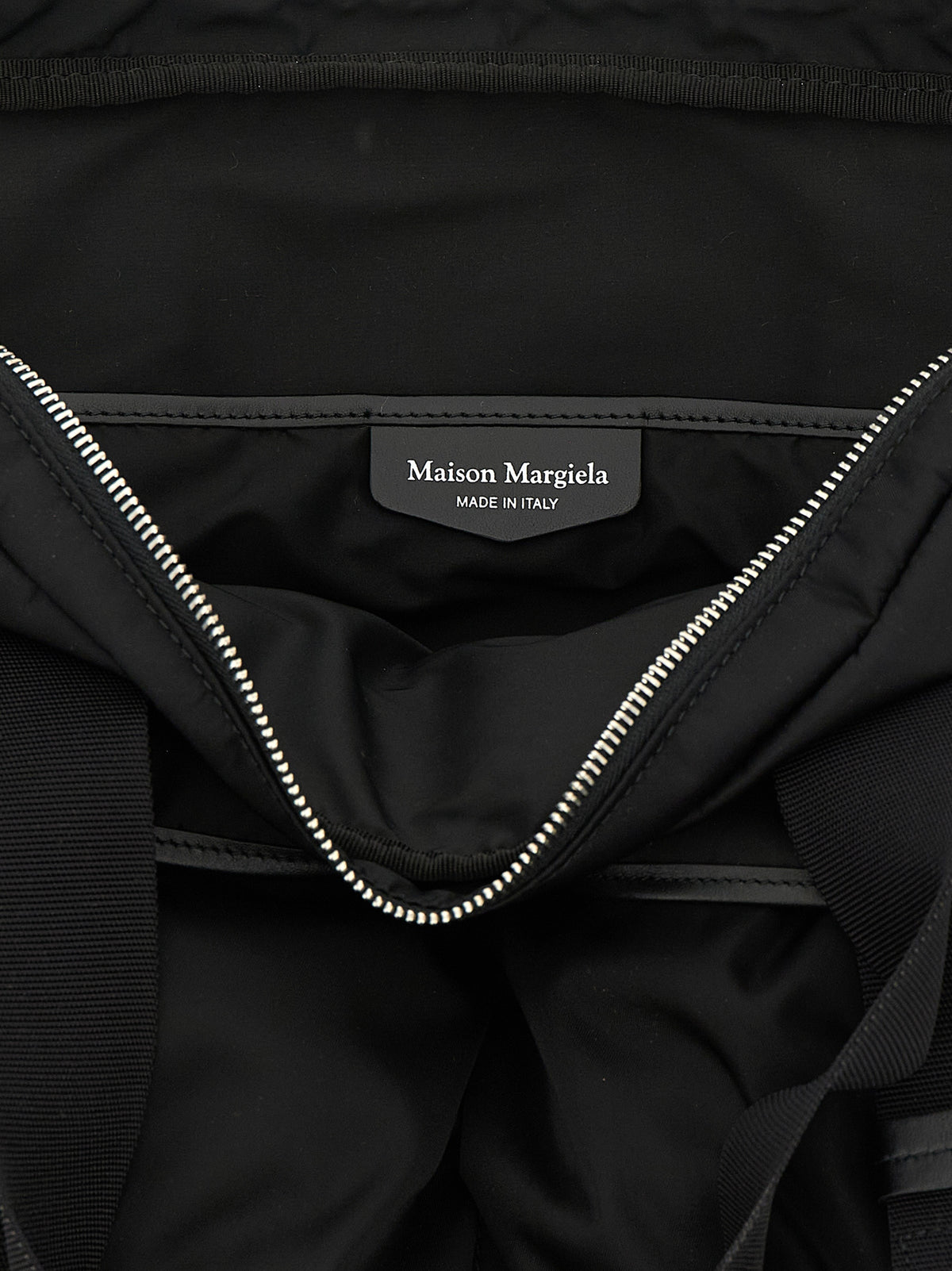 Discover the Maison Margiela Black Polyamide Tote Bag, a fusion of industrial elegance and timeless allure, crafted for those who command sophistication in every moment.