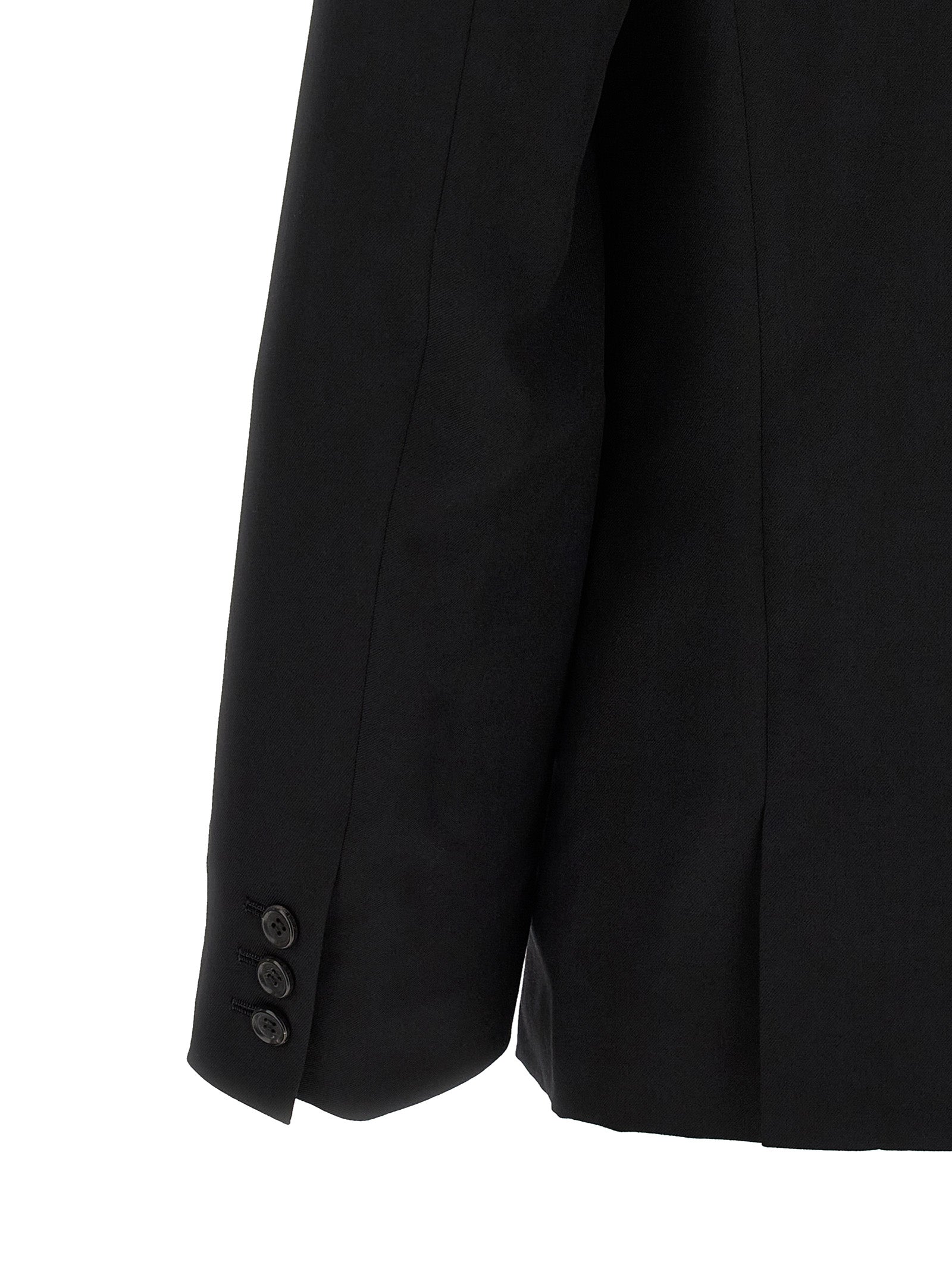 Elevate your wardrobe with the Comme Des Garçons Black Wool Blazer, a masterpiece of avant-garde design and luxurious craftsmanship, embodying timeless elegance and sophistication.