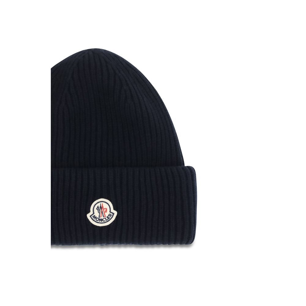 Elevate your winter elegance with the Moncler Blue Wool Oves Aries Beanie, a luxurious blend of fleece wool and cashmere, perfect for discerning tastes.