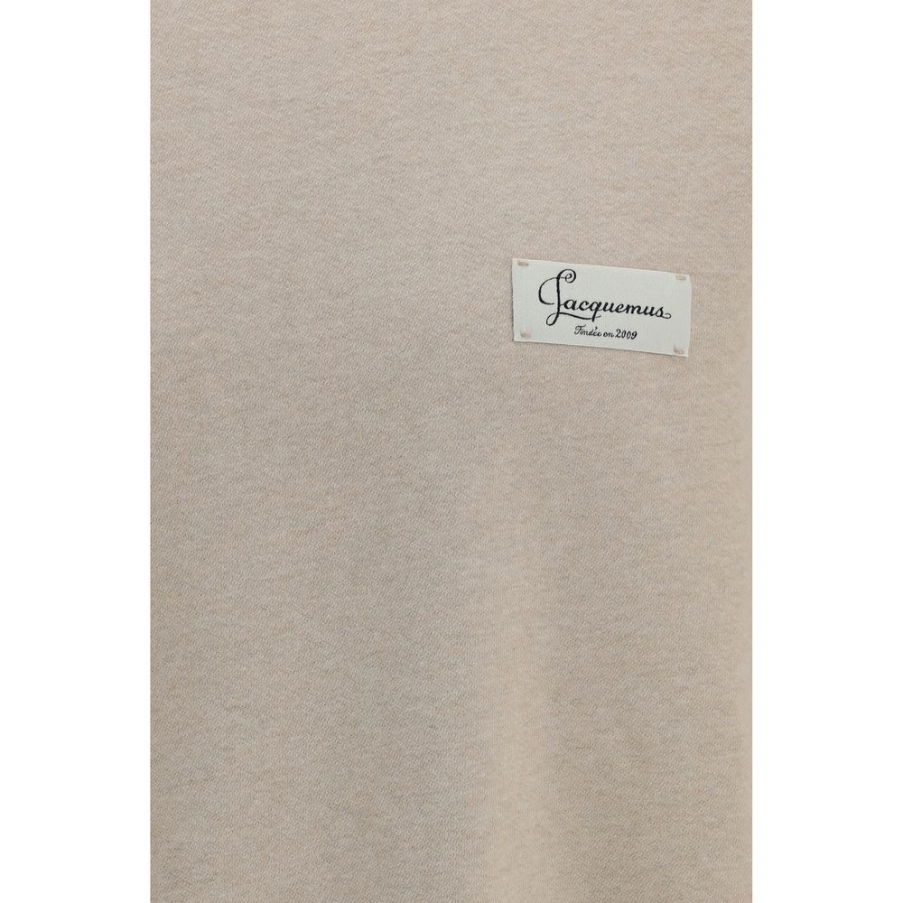 Indulge in the Jacquemus Beige Cotton Sweatshirt, a masterpiece of soft cotton fleece that redefines elegance with its oversized silhouette and exquisite detailing.