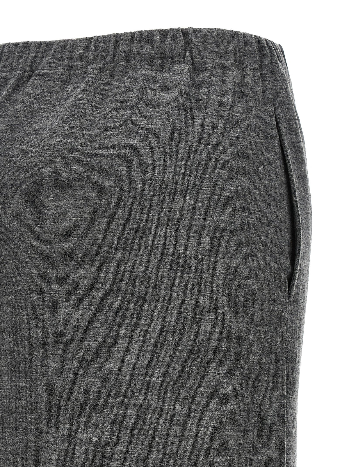 Indulge in the exquisite Junya Watanabe Gray Wool Midi Skirt, a masterpiece of luxury craftsmanship that seamlessly blends elegance and versatility for the discerning individual.