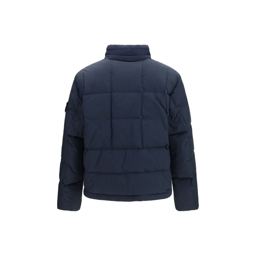 Indulge in the Stone Island Blue Goose Down Shell Jacket, a luxurious blend of comfort and sophistication, perfect for the modern connoisseur seeking elegance and warmth.