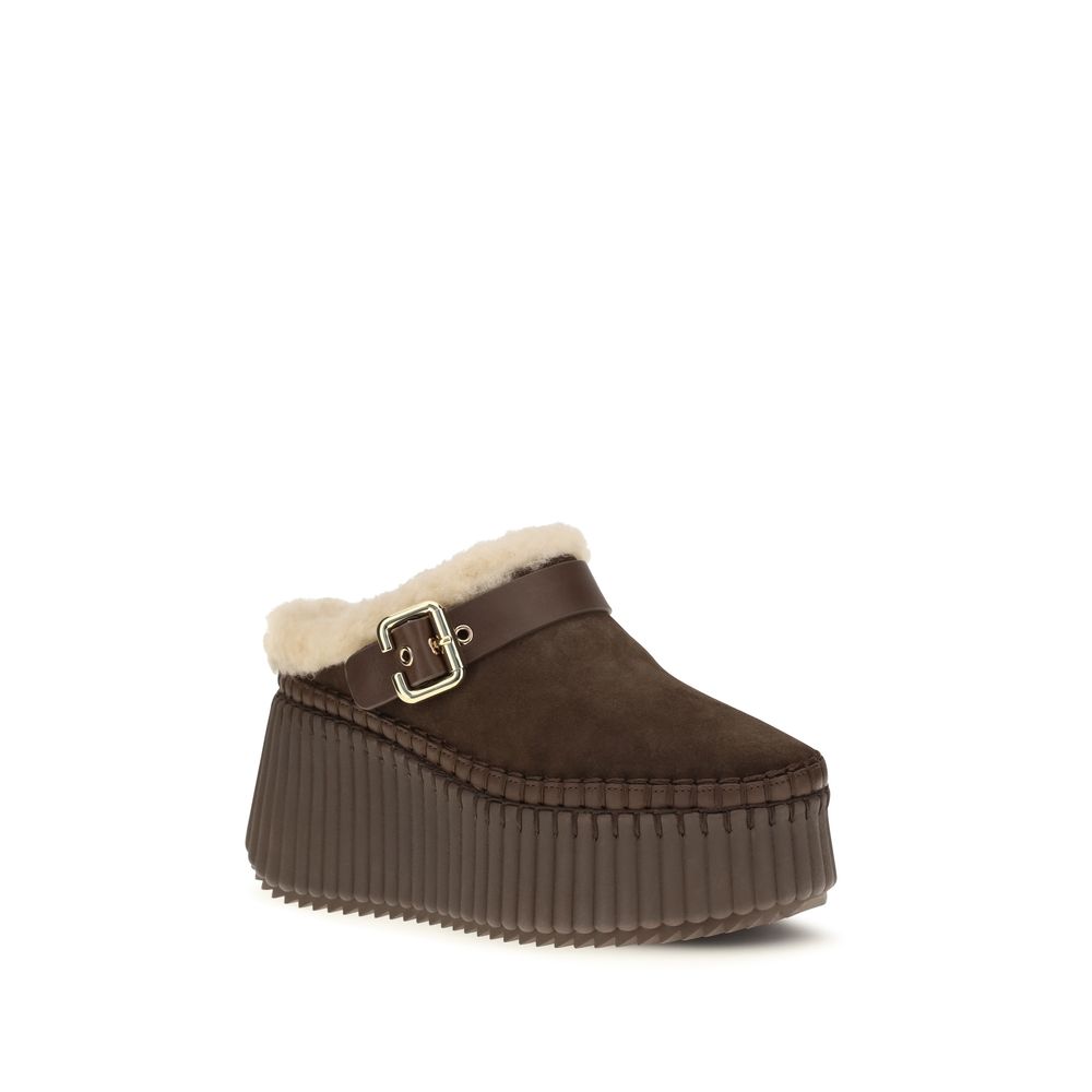 Indulge in the Chloé Brown Calf Leather Bos Taurus Mules, where exquisite craftsmanship meets sustainable luxury, redefining elegance for the discerning modern individual.