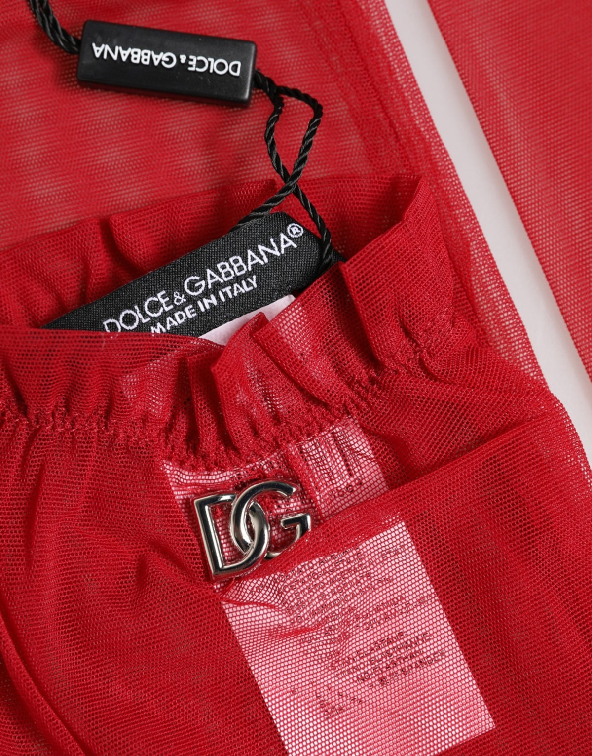 Indulge in the allure of Dolce & Gabbana's Red Acetate Sheer Elbow Length Mitten Gloves, where exquisite Italian craftsmanship meets modern elegance, perfect for any sophisticated occasion.